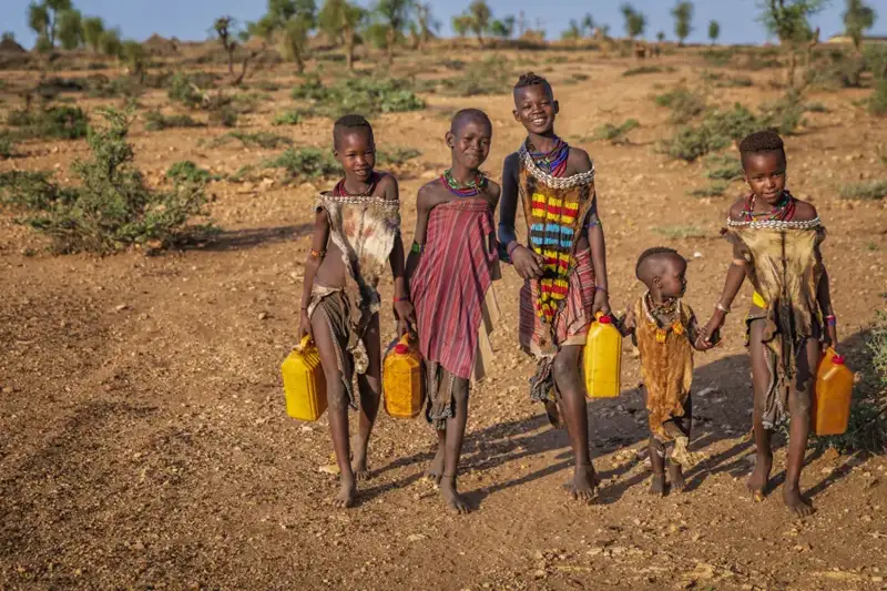 Children carrying water containers