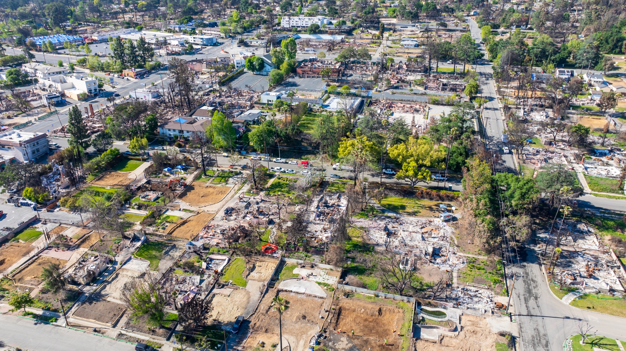Aerial view of fire-damaged homes and businesses in Altadena